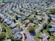 Aerial view of the property showing the location in a residential community surrounded by greenery at 3360 Richmond Dr, The Villages, FL 32162