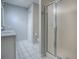 Clean bathroom with updated shower and white tile floor at 3360 Richmond Dr, The Villages, FL 32162