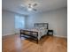 Bright bedroom features a ceiling fan and hardwood floors, complemented by natural light at 3360 Richmond Dr, The Villages, FL 32162