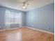 Bedroom with hardwood flooring, sheer curtains, and bright, natural light at 3360 Richmond Dr, The Villages, FL 32162