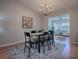 Spacious dining room boasts modern chandelier and artwork, flowing into the living space at 3360 Richmond Dr, The Villages, FL 32162