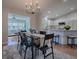 Cozy dining room featuring a modern chandelier and an open layout to the living room and the kitchen at 3360 Richmond Dr, The Villages, FL 32162