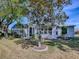 Home exterior showcasing a screened-in patio, mature landscaping, and a well-maintained lawn at 3360 Richmond Dr, The Villages, FL 32162
