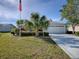 Charming single-story home with a well-manicured front yard and paved driveway at 3360 Richmond Dr, The Villages, FL 32162