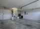 Uncluttered garage with storage shelves and ceiling fan, ready for vehicles and projects at 3360 Richmond Dr, The Villages, FL 32162
