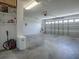 Spacious garage with ample storage and a modern garage door at 3360 Richmond Dr, The Villages, FL 32162