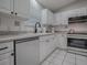 Bright kitchen with white cabinetry, modern appliances, and tile backsplash and flooring at 3360 Richmond Dr, The Villages, FL 32162
