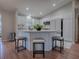 Bright eat-in kitchen features a central island with breakfast bar, white cabinetry, and recessed lighting at 3360 Richmond Dr, The Villages, FL 32162