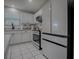 Bright kitchen featuring white cabinets, tile backsplash, stainless steel appliances, and tiled floor at 3360 Richmond Dr, The Villages, FL 32162