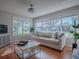 Bright living room featuring hardwood floors, large windows, and neutral-toned furniture at 3360 Richmond Dr, The Villages, FL 32162