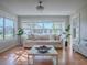 Sun-filled living room with large windows, hardwood floors, and neutral decor at 3360 Richmond Dr, The Villages, FL 32162