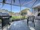 Back patio with grill, outdoor seating, and views of the backyard at 3360 Richmond Dr, The Villages, FL 32162