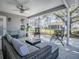 Relaxing screened patio featuring wicker seating and a ceiling fan at 3360 Richmond Dr, The Villages, FL 32162