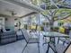 Covered patio with comfortable seating, ceiling fan, and views of the green backyard at 3360 Richmond Dr, The Villages, FL 32162