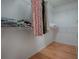 Walk-in closet with ample shelving and hardwood floors at 3360 Richmond Dr, The Villages, FL 32162