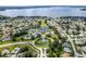 Wide aerial view of a community with a large lake, a community center, and well-maintained landscaping at 5441 Sea Leopard St, Tavares, FL 32778