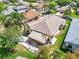 Home featuring a striped awning, outdoor patio, white rocks, and beautiful landscaping at 5441 Sea Leopard St, Tavares, FL 32778