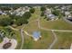 Expansive green space with winding walking paths, a gazebo, and neatly landscaped homes in a tranquil neighborhood at 5441 Sea Leopard St, Tavares, FL 32778