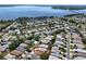 Panoramic aerial view showcasing a community with mature trees and lake views at 5441 Sea Leopard St, Tavares, FL 32778