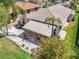 Home featuring a striped awning, outdoor patio, white rocks, and beautiful landscaping at 5441 Sea Leopard St, Tavares, FL 32778