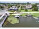 Aerial view showcasing seaplanes docked near a lakeside property with boat dock, surrounded by lush greenery and trees at 5441 Sea Leopard St, Tavares, FL 32778
