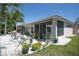 Charming home featuring a screened lanai, outdoor patio, and a well-manicured lawn at 5441 Sea Leopard St, Tavares, FL 32778