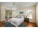 Cozy bedroom with a ceiling fan and sliding glass doors to the outdoors at 5441 Sea Leopard St, Tavares, FL 32778