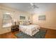 Comfortable bedroom features stylish decor, hardwood floors, and plenty of natural light at 5441 Sea Leopard St, Tavares, FL 32778