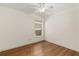 A simplistic bedroom design with a single window and hardwood flooring at 5441 Sea Leopard St, Tavares, FL 32778