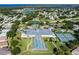 Aerial photo featuring the community center with an enclosed pool and tennis courts at 5441 Sea Leopard St, Tavares, FL 32778