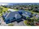 Aerial view of a large community center with a covered pool area, parking, and a beautiful lake in the background at 5441 Sea Leopard St, Tavares, FL 32778