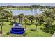 Entrance to Tavares, the America's Seaplane City, featuring lush landscaping, palm trees, and a pond with fountains at 5441 Sea Leopard St, Tavares, FL 32778