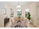 Bright dining area with bay window and decorative hanging lamp at 5441 Sea Leopard St, Tavares, FL 32778