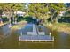 Aerial shot of a private wooden dock with benches, providing a peaceful waterfront retreat on the lake at 5441 Sea Leopard St, Tavares, FL 32778