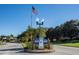 Royal Harbor entrance sign with manicured landscaping and a vintage-style lamp post and flagpole at 5441 Sea Leopard St, Tavares, FL 32778