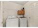 Laundry room with modern washer and dryer units, and built in shelving at 5441 Sea Leopard St, Tavares, FL 32778
