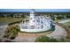 Unique lighthouse replica with surrounding landscaping and paved walkway in a residential neighborhood at 5441 Sea Leopard St, Tavares, FL 32778