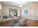 Comfortable living room featuring wood floors, sliding glass door, and modern decor at 5441 Sea Leopard St, Tavares, FL 32778