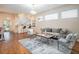 Well-lit living room featuring modern furniture, hardwood floors, and an open layout to the kitchen at 5441 Sea Leopard St, Tavares, FL 32778