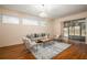 Bright living room with hardwood floors, modern decor, and sliding glass doors to a screened porch at 5441 Sea Leopard St, Tavares, FL 32778