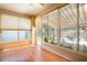 Bright sunroom with wood floors and lots of natural light from large windows and a door to patio at 5441 Sea Leopard St, Tavares, FL 32778