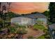 Backyard aerial view featuring a pool, patio, lush landscaping and a brick walkway at 10417 Lake Louisa Rd, Clermont, FL 34711
