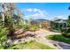 Beautiful backyard featuring lush landscaping, a brick pathway, and a screened pool area at 10417 Lake Louisa Rd, Clermont, FL 34711