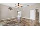 Bedroom with tile floors, open doorways, and neutral colored walls and trim at 10417 Lake Louisa Rd, Clermont, FL 34711