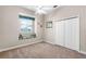 Cozy bedroom features a window seat, a ceiling fan, neutral walls, and carpeted floors at 10417 Lake Louisa Rd, Clermont, FL 34711