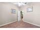 Neutral bedroom featuring wall art and access to the staircase at 10417 Lake Louisa Rd, Clermont, FL 34711
