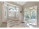 Bright breakfast nook features a window bench seat, shuttered window and glass doors to a screened in porch at 10417 Lake Louisa Rd, Clermont, FL 34711