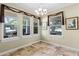 Cozy dining area filled with natural light, tile flooring, and decorative window treatments at 10417 Lake Louisa Rd, Clermont, FL 34711