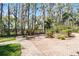 Long brick driveway leading to a wrought iron gate surrounded by mature landscaping at 10417 Lake Louisa Rd, Clermont, FL 34711