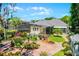 Aerial shot of the home with a screened-in pool, beautiful landscaping, and manicured lawn at 10417 Lake Louisa Rd, Clermont, FL 34711